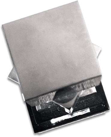 A tall silver trophy with a black base, viewed from above; It's a little dusty. The trophy is composed of 3 silver squares stacked atop eachother, with the middle on rotated 45 degrees.